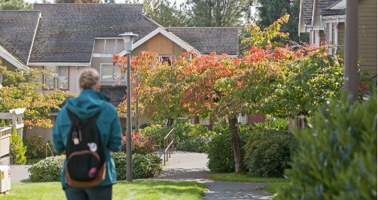 Person walking along a path in the family housing complex